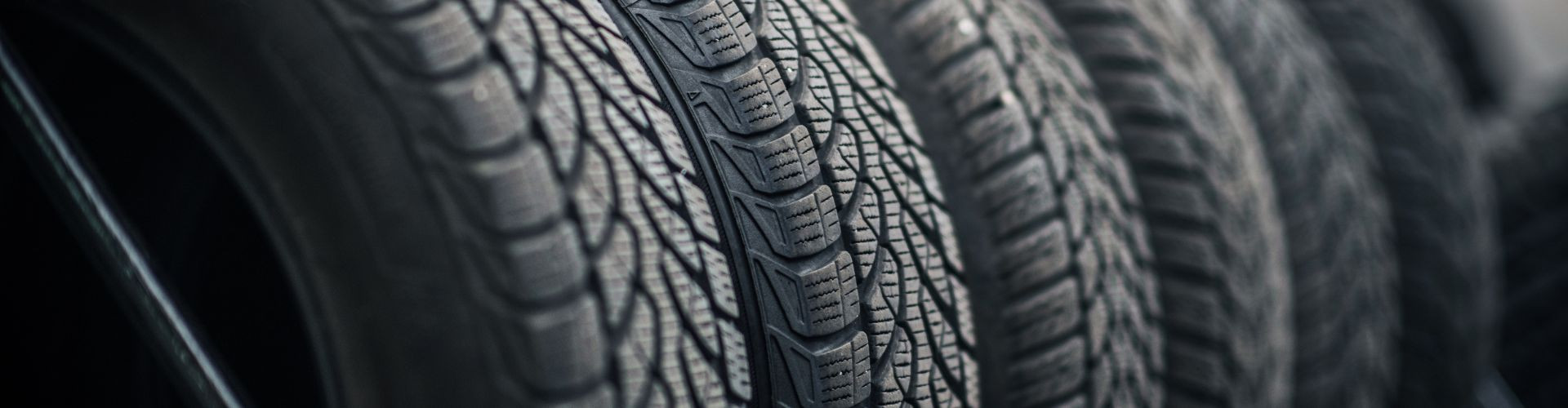 New tires on a tire rack | Ultra Tune Automotive Ltd.